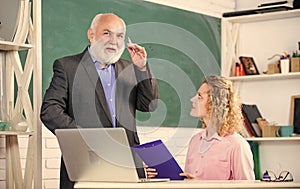 Communicate clearly and effectively. Work in education. Man mature school teacher and girl student with laptop. High