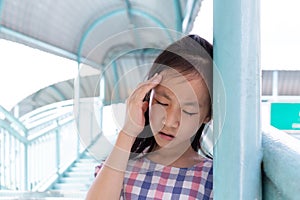 Communicates the symptoms of vertigo,dizziness,migraine,sick depressed girl suffering from headache,Asian girl on the pedestrian photo