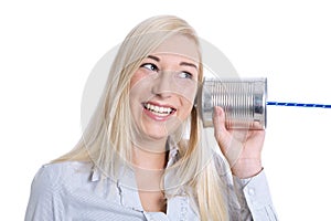 Communication or advertising concept: young smiling isolated woman calling with tin can.