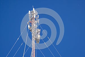 Communication antenna tower in blue sky background