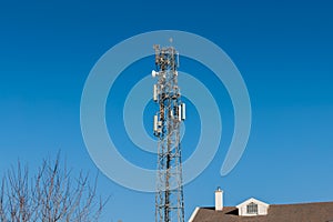 Communication Antenna Transmitter. Telecommunication tower. Wireless 3G, 4G and 5G Cell Site in front of blue sky photo