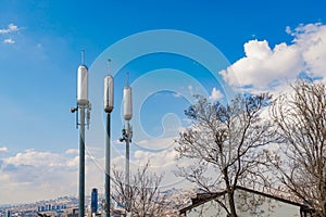 Communication Antenna Transmitter. Telecommunication tower. Wireless 3G, 4G and 5G Cell Site in front of blue sky photo