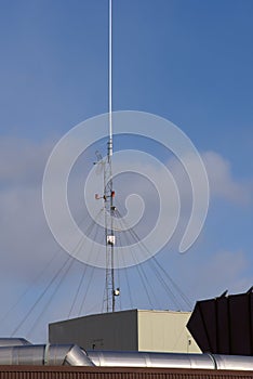 Communication antennae on a business rooftop.