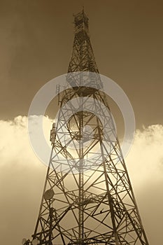 Communication antennae on a misty day in warm tone