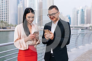 Communication business. Two businessmen and woman walking on the street in the park and talk to each other and show missed calls