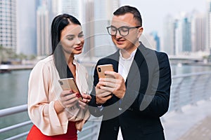 Communication business. Two businessmen and woman walking on the street in the park and talk to each other and show missed calls