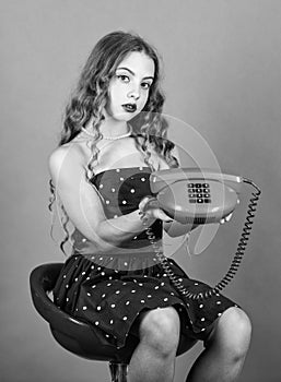 Communication concept. Shopping online. Retro girl speak phone. Outdated device. Kid talking vintage phone. Pinup girl