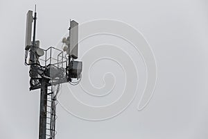 communication and gsm, wcdma, hspda and other 3g, 4g standarts tower close-up in cloudy weather