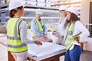 Communication is important in the construction industry. a group of construction workers looking over building plans