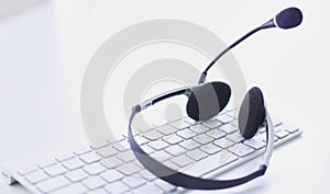 Communication support, call center and customer service help desk. VOIP headset on laptop computer keyboard