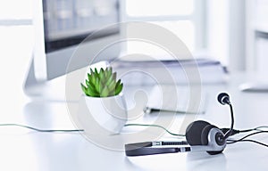 Communication support, call center and customer service help desk. VOIP headset on laptop computer keyboard