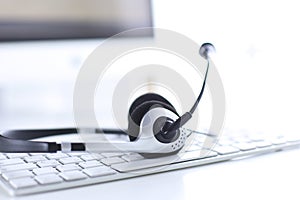 Communication support, call center and customer service help desk. VOIP headset on laptop computer keyboard