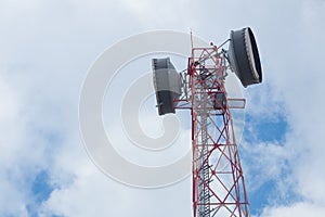 Communication Tower with antenna and satellite dish telecom network on blue sky background.