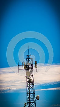 Communication tower on blue sky.