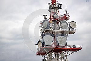 communication tower with control devices and antennas, transmitters and repeaters for mobile communications and the