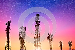 Communication towers on dusk sky, powering 4G and 5G networks. variety network cell site silhouette against vibrant morning sky