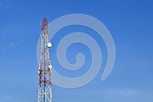 communication transmitter tower with wireless antennas and satellite dish