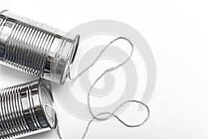 Communications and business calls concept of tin can telephone with string on orange
