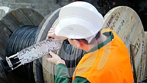 A communications engineer works with an optical fiber cable.