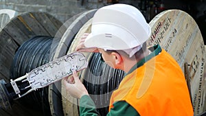 A communications engineer works with an optical fiber cable.