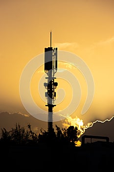 Communications mast in silhouette at sunset