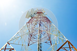 Communications tower with antennas against blue sky