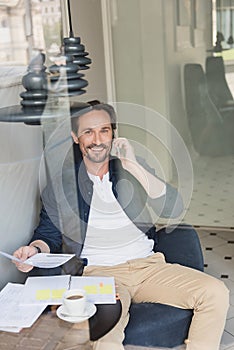 Communicative businessman having break in cafe