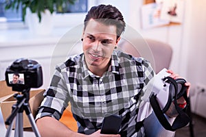 Communicative professional blogger sitting in his studio