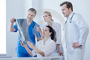Communicative therapists examining x ray photo in the examination room