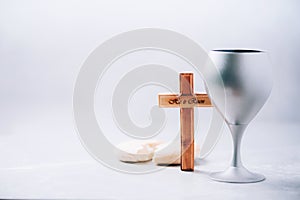 Communion still life. Unleavened bread, chalice of wine on grey background. Christian communion concept for reminder of Jesus
