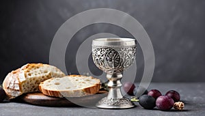 Communion still life unleavened bread chalice of wine silver kiddush wine cup on grey background