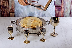 Communion still life wine, bread and Bible. Reading the Bible at the beginning of communion