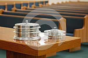 Communion Trays on Table Before Empty Church Pews