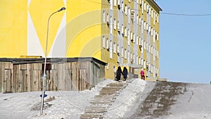 Communism block atmosphere. Russia. Tiksi. Siberia. Old people in on street of Tiksi. Abandoned housing block in northern Siberia.