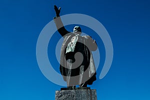 Communist bronze monument to Lenin against the blue sky in Russia