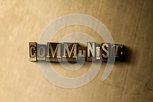 COMMUNIST - close-up of grungy vintage typeset word on metal backdrop