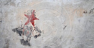 Communistic symbol: Grungy red star graffiti on and old wall