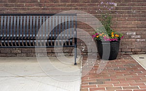 Community City Park bench beside decorative planter