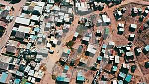 Community, drone and houses in poor neighborhood or dirt road in village with landscape of South Africa. Township