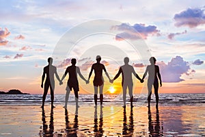 Community or group concept, silhouettes of people standing together and holding hands, team