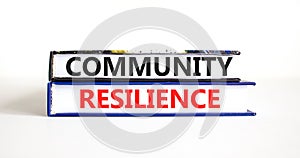 Community resilience symbol. Concept word Community resilience typed on books. Beautiful white table white background. Business