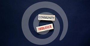 Community resilience symbol. Concept word Community resilience typed on wooden blocks. Beautiful black table black background.