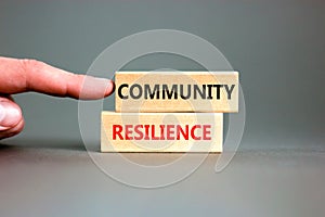 Community resilience symbol. Concept word Community resilience typed on wooden blocks. Beautiful grey table grey background.