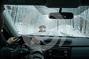 A commuter driving in a winter snow storm