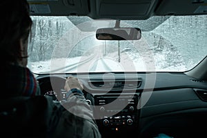 A commuter driving in a winter snow storm