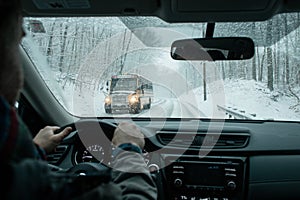 A commuter driving in a winter snow storm