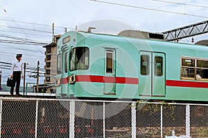 Commuter train with conductor standing in front