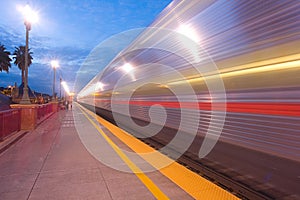 Commuter Train departing at Twilight photo