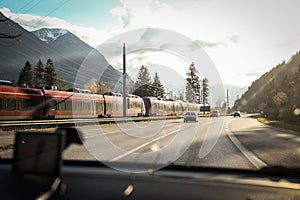 Commuter train passing cars