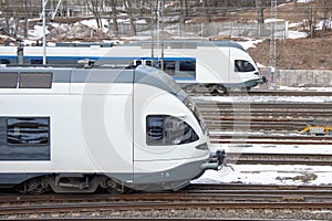 Commuter trains overtake each other on the railroad photo